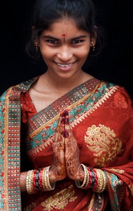 namaste_greeting_with_young_girl_wearing_sari_big_smile